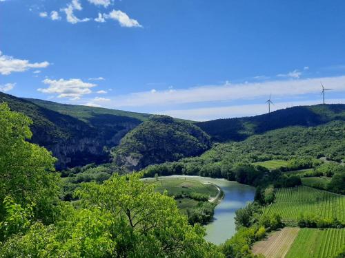 a view of a river with wind turbines in the distance at APPARTAMENTO AL FORTE in Rivoli Veronese