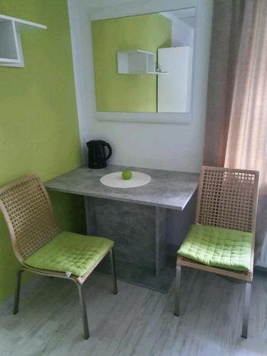a bathroom with a counter with a sink and two chairs at Lindner Ferienwohnungen und Doppelzimmer in Fichtelberg
