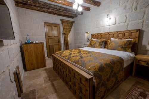 a bedroom with a large bed in a room at Underground Cave Suites Hotel in Goreme