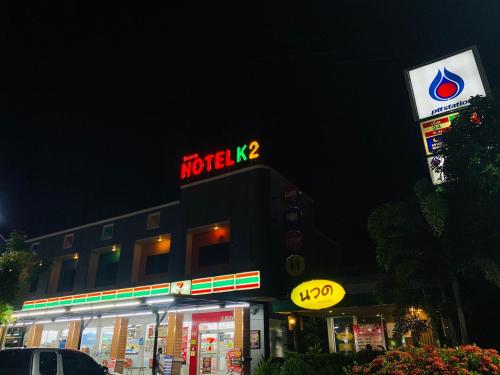 a building with a motel sign and a neon sign at K2 Hotel @ Airport in Surat Thani