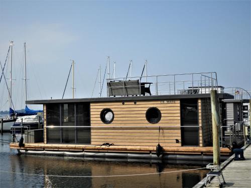 a small wooden boat sitting in the water at Hausboot-LaFe Flensburger Förde in Egernsund