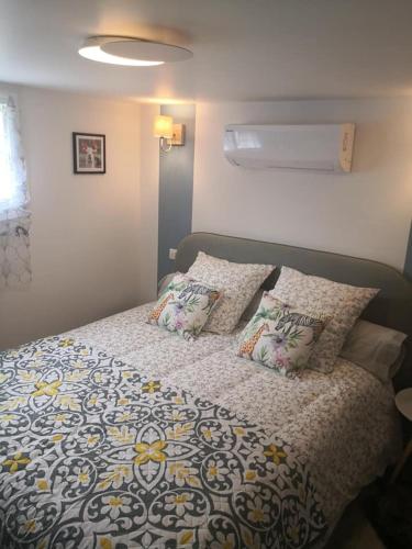 a bed with pillows on it in a bedroom at La Bulle Bleue Futuroscope in Chasseneuil-du-Poitou