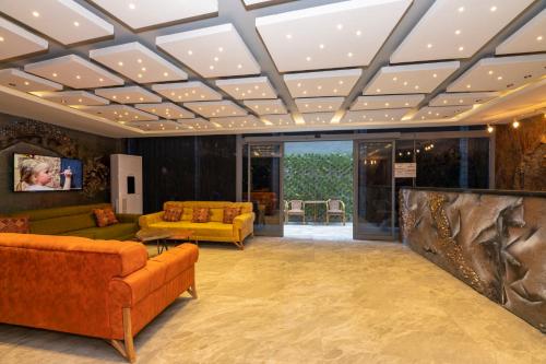 a living room with couches and a ceiling with lights at White Palace Hotel in Istanbul