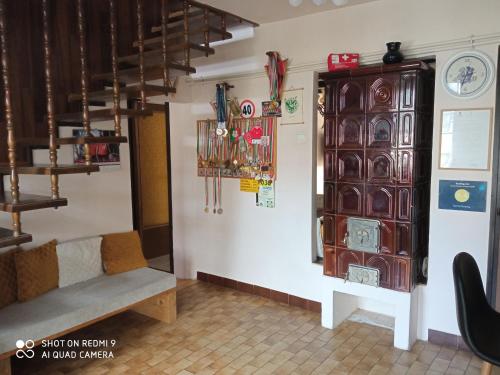 a room with a bench and a wall with clocks at Nyírfás Camping in Nagykanizsa