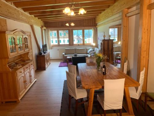 a dining room with a wooden table and chairs at Apartmenthaus Edelweiss in Gosau in Gosau