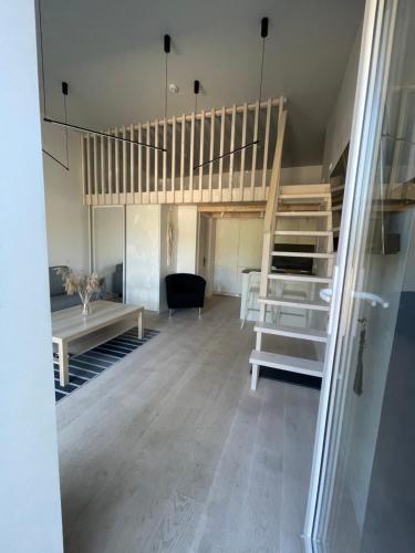 a room with a loft bed and a desk at Alyvų Namai Nida in Nida