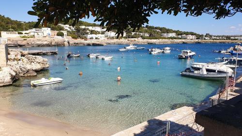 a body of water with boats and people in it at Giulia's House in Galatina