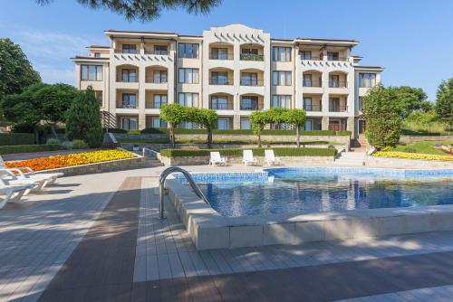 a building with a swimming pool in front of a building at View Apartments in Sozopol