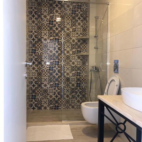 a bathroom with a shower with a toilet and a sink at Belami luxury apartments in Ulcinj