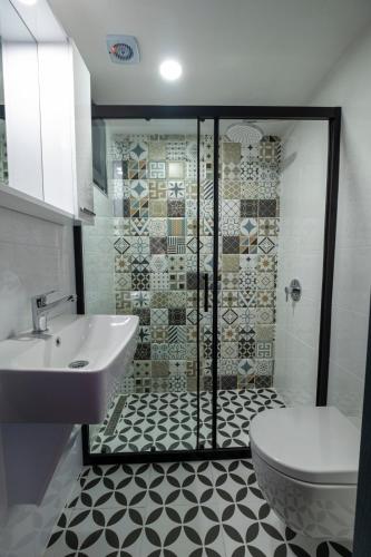 a bathroom with a shower and a toilet and a sink at Solo Boutique Hotel in Antalya