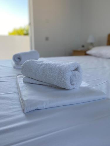 two towels sitting on top of two beds at Sunset View Apartment, in Nature - El Greco Apartments No 6 in Kos