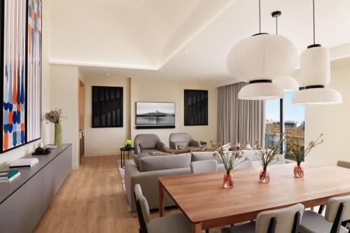 a dining room and living room with a table and chairs at Nobu Hotel London Portman Square in London
