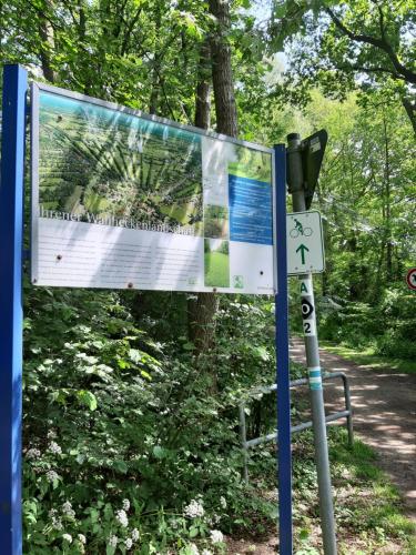 a sign next to a parking meter on a trail at Ferienwohnung Am Ostfriesland-Wanderweg in Rhauderfehn
