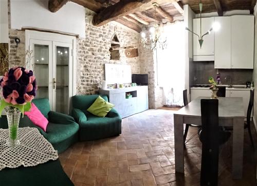 sala de estar con sofá verde y mesa en Non ditelo al Duca - Belvedere Sant'Angelo, en Spoleto