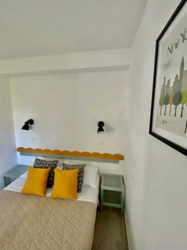 une chambre avec un lit avec des oreillers jaunes dans l'établissement La suite new-yorkaise Disneyland Paris, à Serris