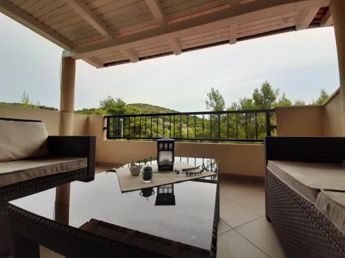 a patio with a table and chairs on a balcony at Apartments Edo in Vis