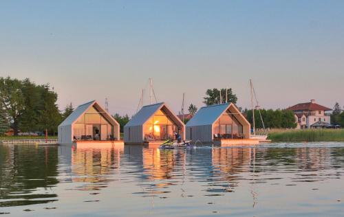 a group of houses on a body of water at Hotel Joseph Conrad SPA & Wellness in Pisz