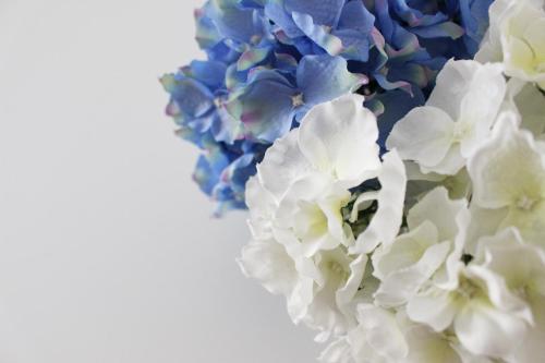 a bouquet of blue and white flowers on a white background at Casa Thalassa in Cefalù