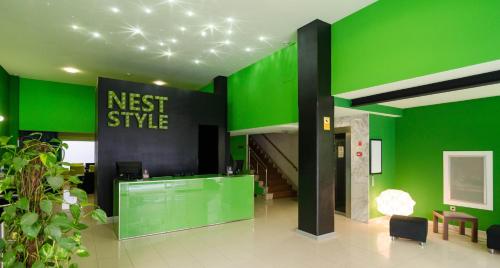 a green room with a clock on the wall at Nest Style Santiago in Santiago de Compostela