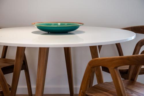 a bowl sitting on top of a table with two chairs at Avra Apartments Kolymbari Harbour in Kolymvari
