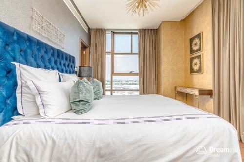 a bedroom with a large bed with a blue headboard at Dream Inn Apartments - City Walk Prime in Dubai