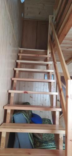 a set of stairs in a tiny house at Domek letniskowy Szramowo (bliźniak) in Szramowo