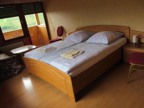 a bedroom with a bed with two books on it at Pension Simon in Reil