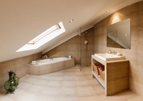 a bathroom with a tub and a sink and a mirror at Casa Clara in Isla de Arosa