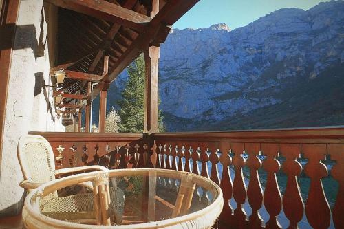 a chair on a balcony with a view of a mountain at Hotel Rebeco in Fuente De