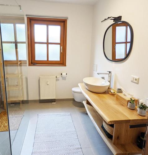 a bathroom with a sink and a mirror at Ferienwohnung Oberammergau in Oberammergau