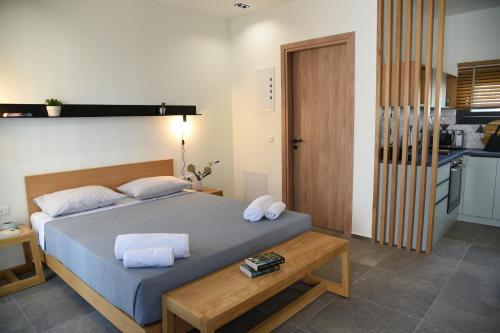a bedroom with a bed with two towels on it at Chill and Thrill Apartments in Mastichari