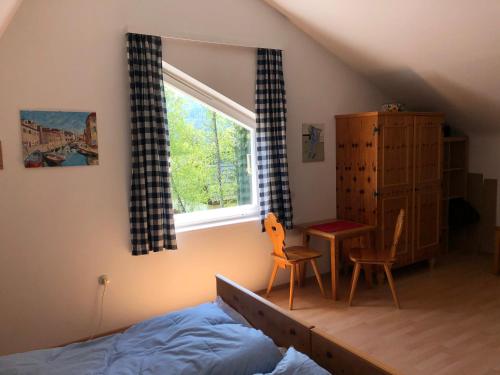 a bedroom with a bed and a window at Haus Max in Bad Mitterndorf