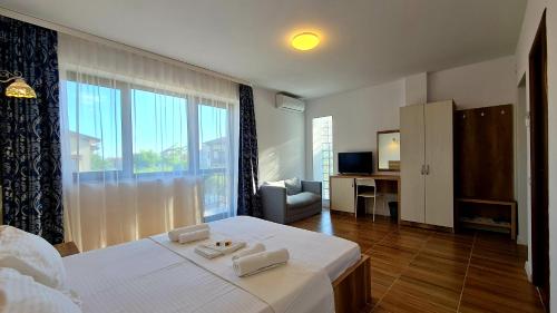 a bedroom with a bed with two towels on it at Elina2 in Techirghiol
