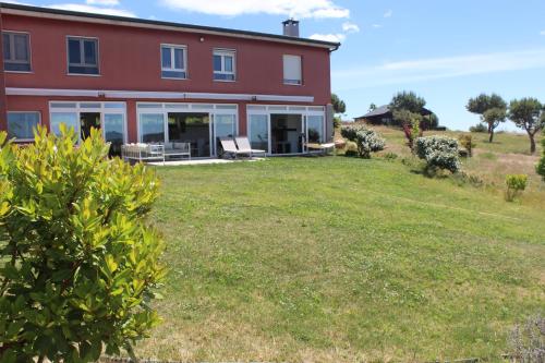 a house with a large yard in front of it at Finca el enebro in Valdemorillo