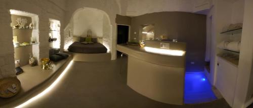 a bathroom with a sink and a bed in a room at Il Fico Deluxe in Ostuni