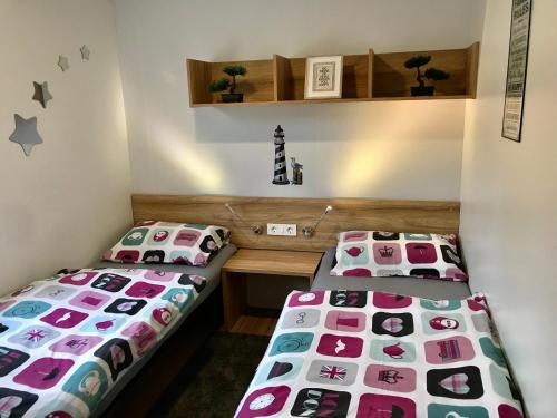 two beds sitting next to each other in a room at M&L Mobile Home in Jezera