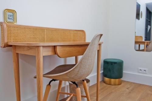 a wooden desk with a chair and a clock at Hotel La Villa Nice Promenade in Nice