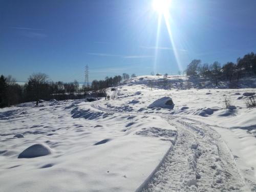 a snow covered hill with the sun in the background at Le Moie in Borgiallo