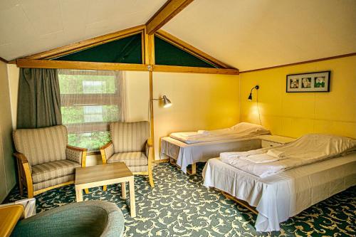 Кровать или кровати в номере Sauda Fjordhotell