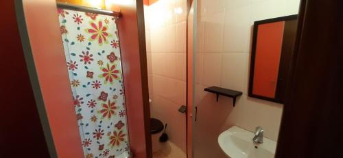 a bathroom with a shower curtain and a sink at Albergue La Costana in Oviedo