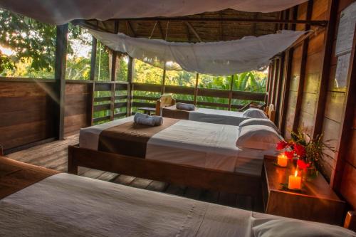 a bedroom with two beds in a tree house at Wasai Tambopata Lodge in Tambopata