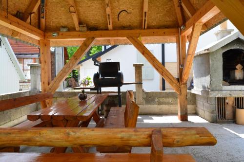 a patio with a wooden table and a chair at MM Apartments in Žabljak