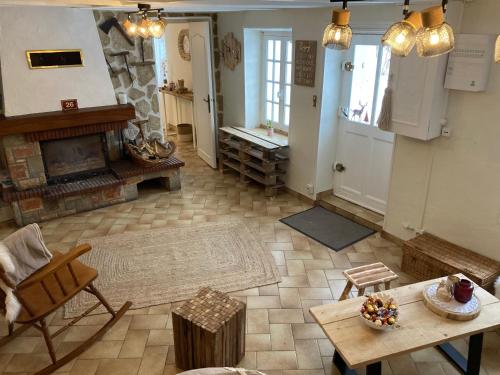 an overhead view of a living room with a fireplace at A la croisée des chemins in Saint-Nicolas-des-Biefs