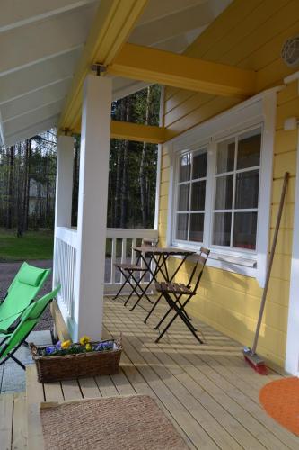 a screened porch with a table and chairs on it at Pikku Torppa Cottage in Kotka