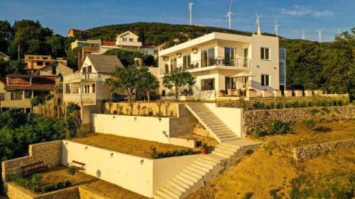 a house on a hill with stairs in front of it at Apartments Blue Heaven in Ulcinj