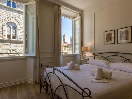 A bed or beds in a room at Locanda dei Poeti Rooms & Apartments