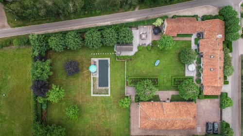 an overhead view of a garden with a house at Wabi Sabi B&B - a Japanese sleep oasis in Belgium in Grote-Brogel