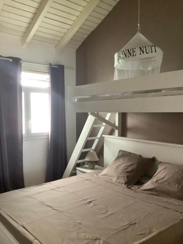 a bedroom with a bunk bed and a bunk ladder at VILLA ALIZEE Appartement 4 in La Ramée