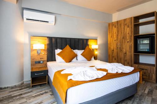 Säng eller sängar i ett rum på Dalya Resort Aqua & Spa Hotel Datça