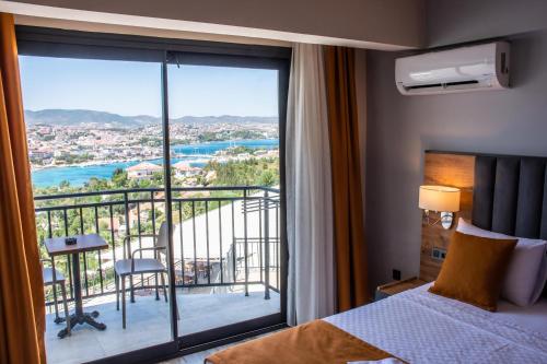a room with a bed and a balcony with a view at Dalya Resort Aqua & Spa Hotel Datça in Datca